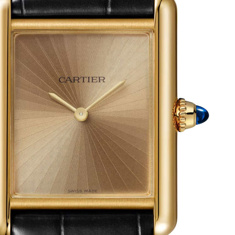 Close-up of gold watch with sunray pattern dial.