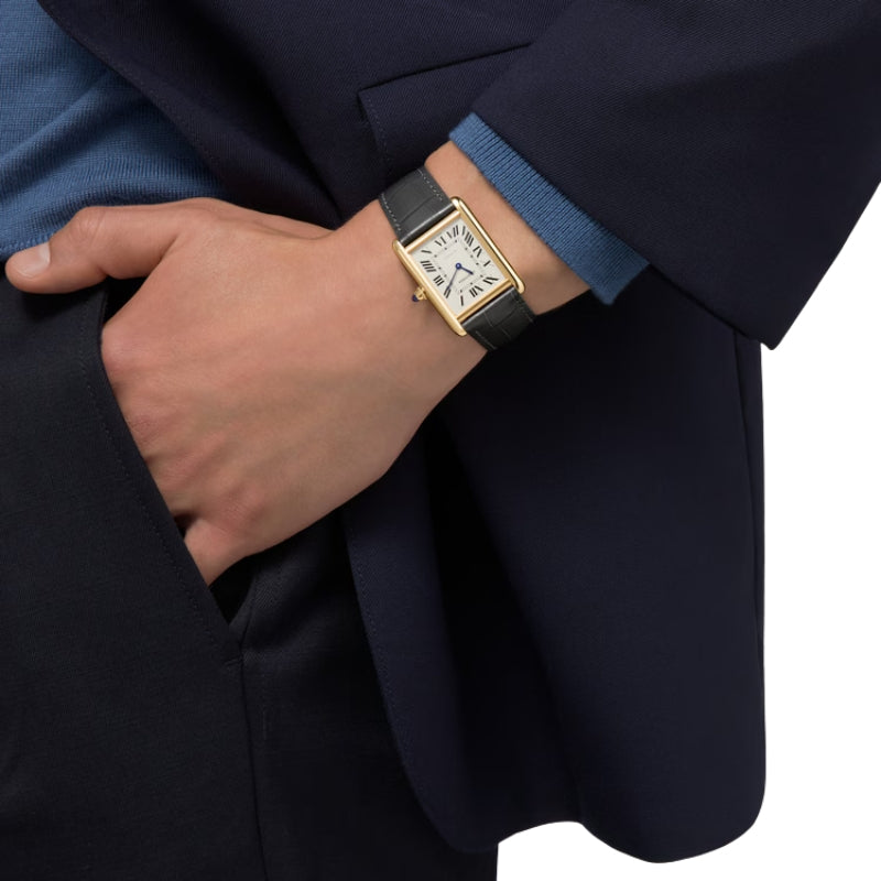 Gold Cartier Tank watch on Men's wrist.