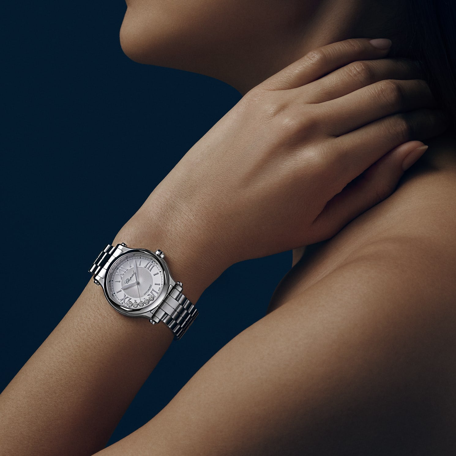 Woman wearing Chopard Happy Sport automatic steel 33mm watch on wrist