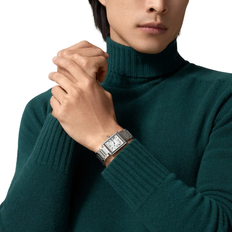 Man wearing silver watch with green turtleneck sweater.