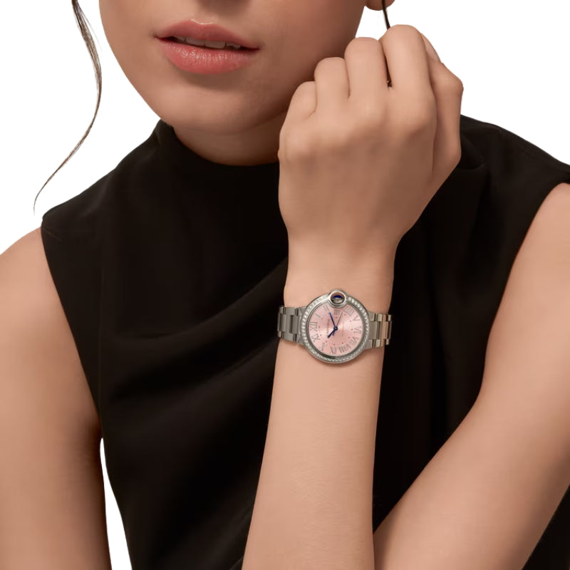 Woman wearing silver luxury watch with black top.