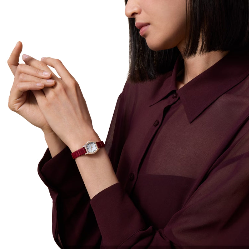Woman wearing small Tortue Cartier watch on wrist.