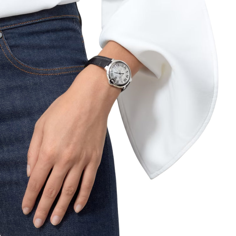 Women wearing Cartier watch with black leather strap.