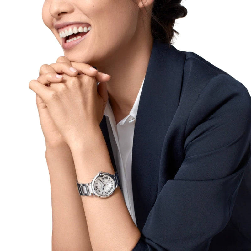 Woman wearing Cartier Ballon Bleu stainless steel watch.