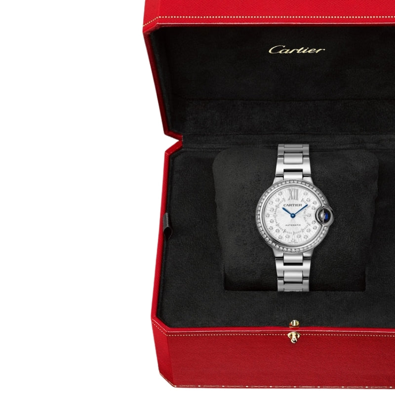 Cartier watch in red box on black cushion.