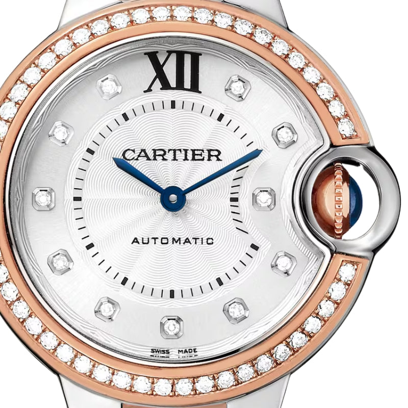 Close up of silver watch face with diamonds.