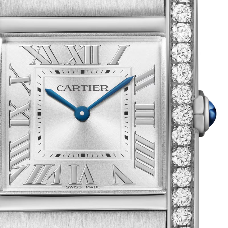 Close-up of silver watch face with diamond bezel.