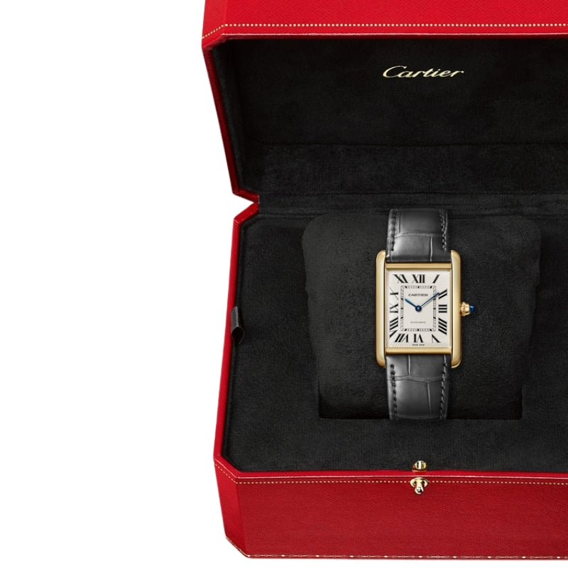 Luxury Cartier watch in red presentation box.