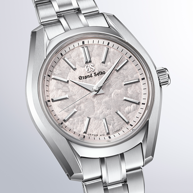 Close-up angled view showcasing the intricate snowflake texture on the watch face.