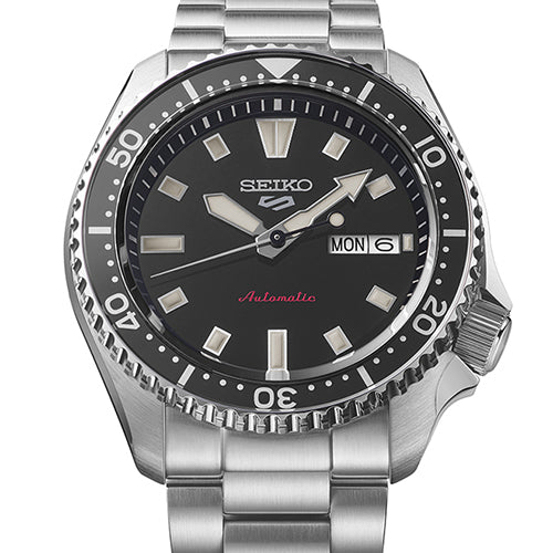 Close-up of silver Seiko watch with black dial.