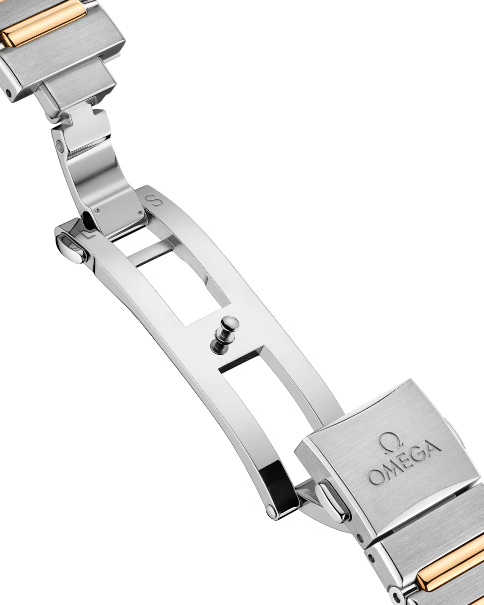 Close-up of open butterfly clasp on metal bracelet.