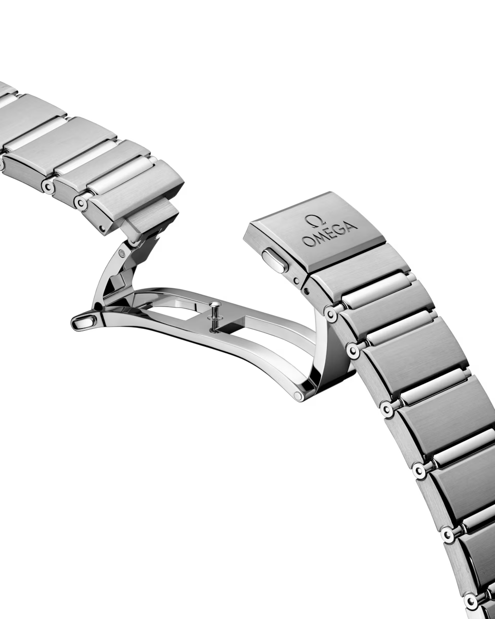 Close-up of an Omega steel watch deployment clasp.