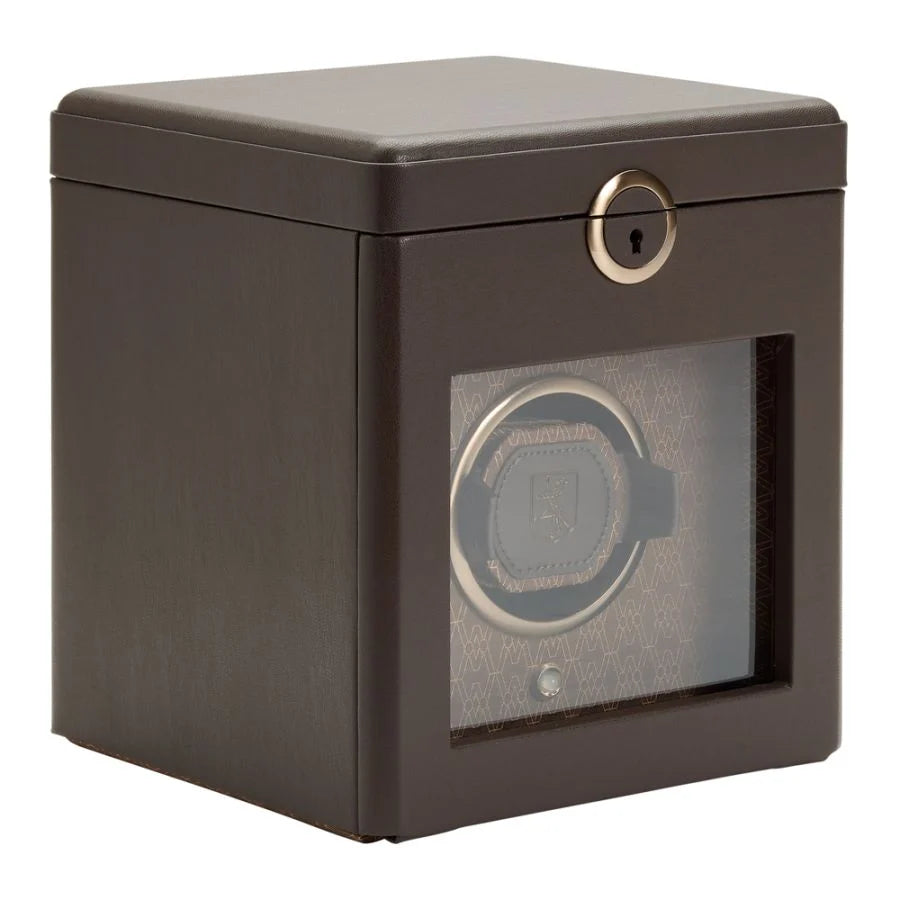 Side perspective view of a closed brown leather watch winder box.