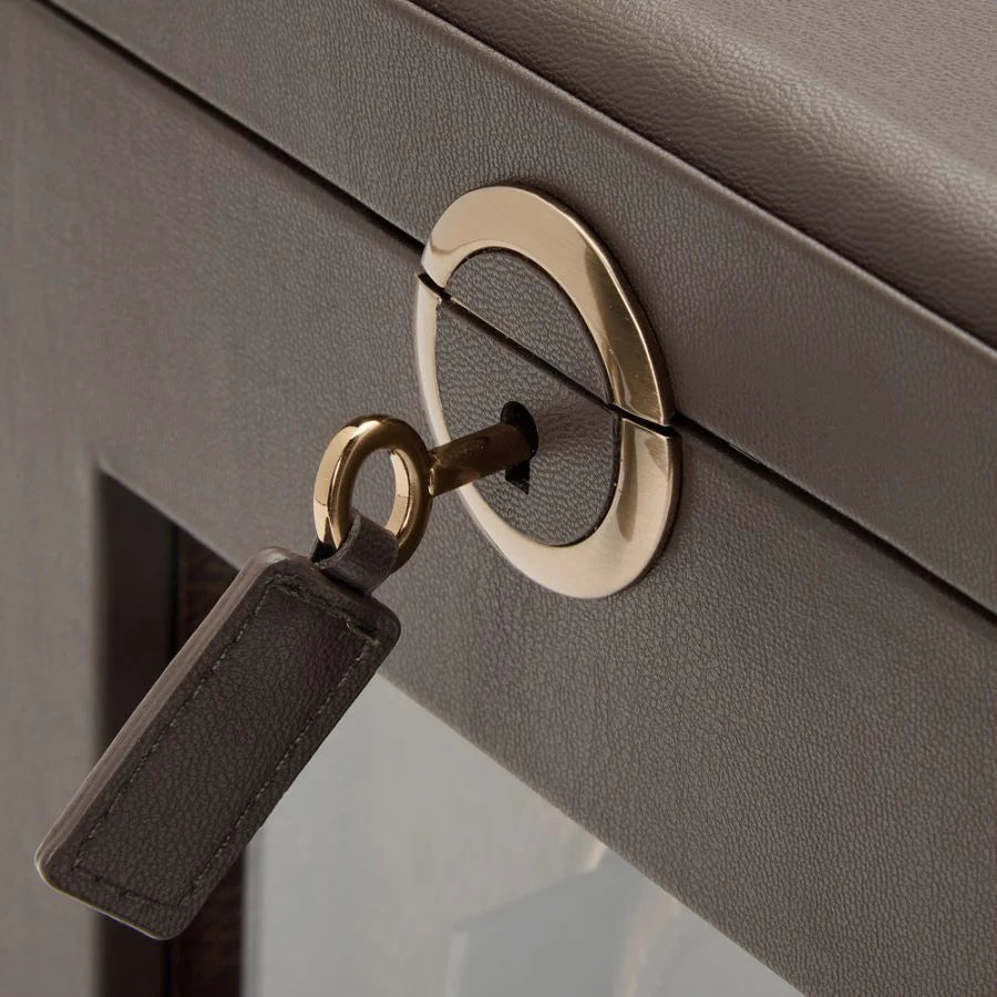 Close up view of a gold key inserted into a lock.