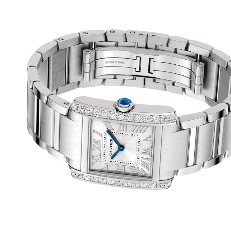 Angled view of silver diamond watch and bracelet.