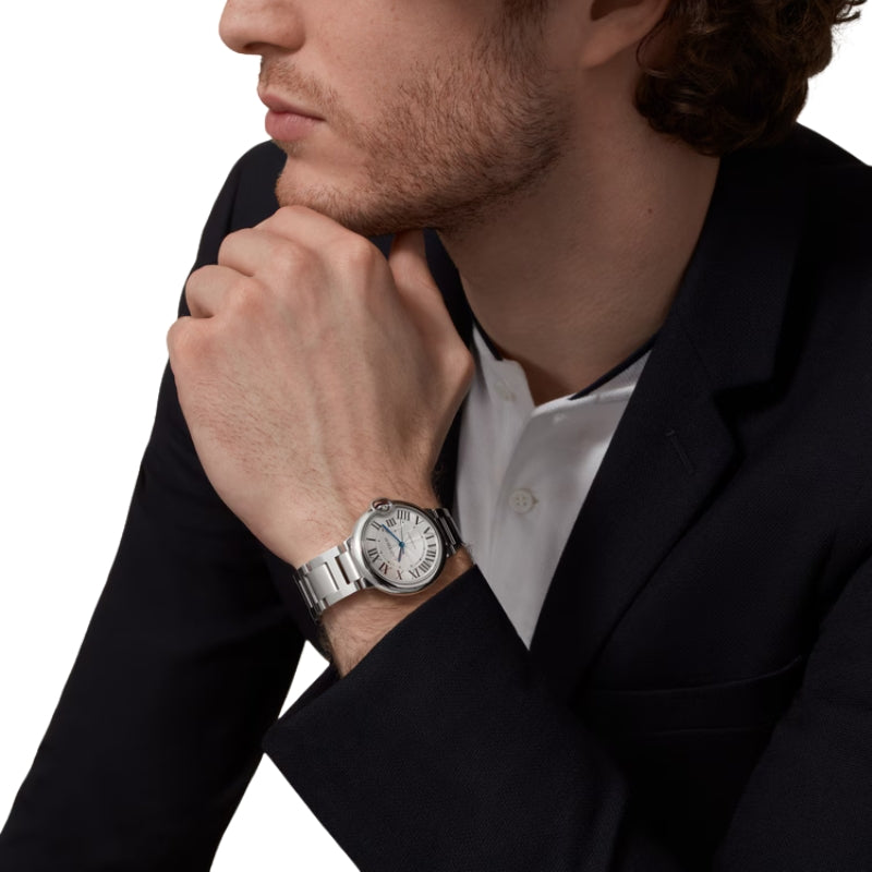 Man wearing Cartier Ballon Bleu stainless steel watch.