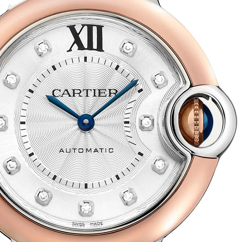 Close-up of watch face with diamonds and crown.