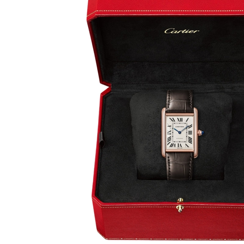 Rose gold Cartier watch inside luxury red box.