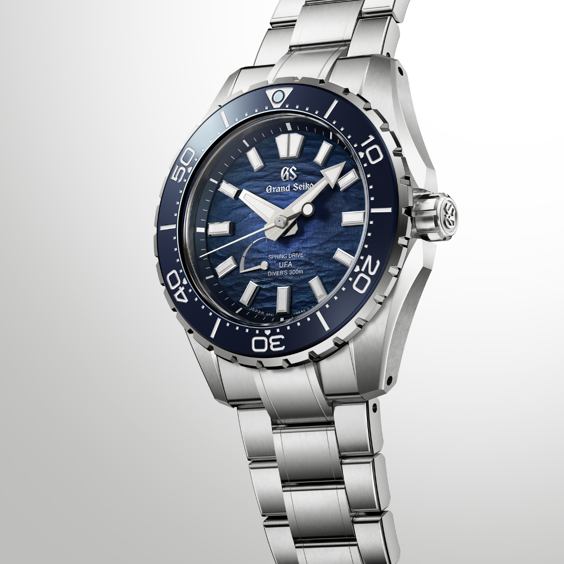 Minimalist aesthetic shot of the watch resting against a clean dark grey backdrop.