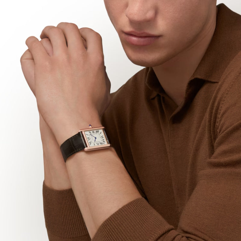 Men wearing rose gold Cartier Tank on wrist.