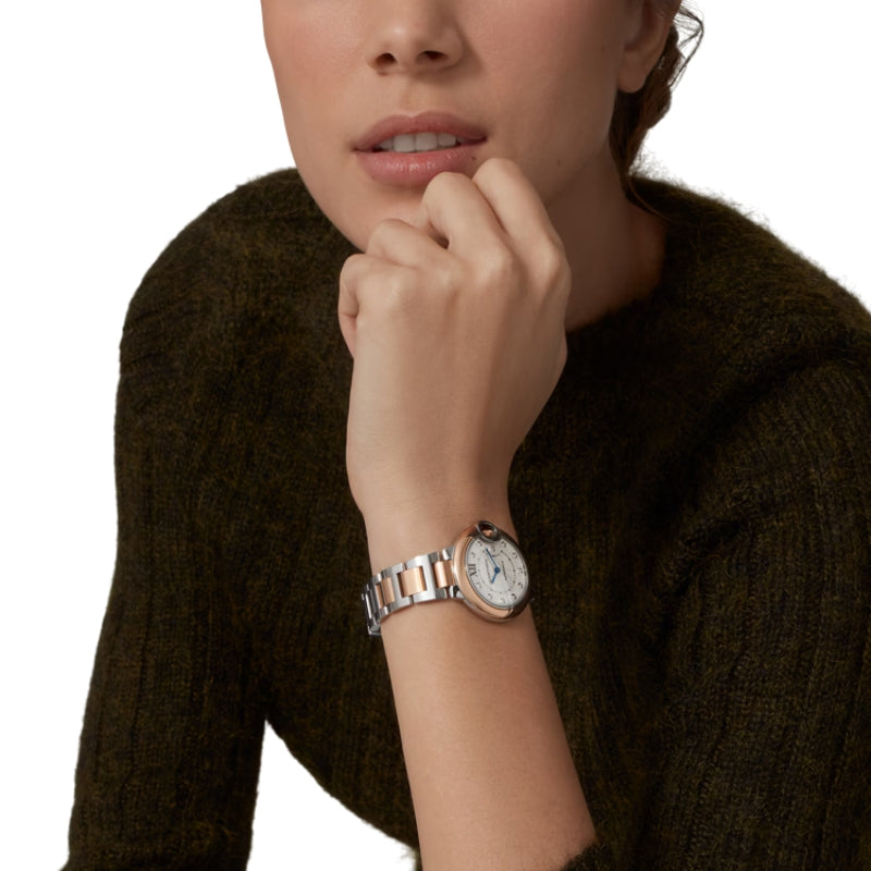 Woman wearing two-tone luxury watch on her wrist.