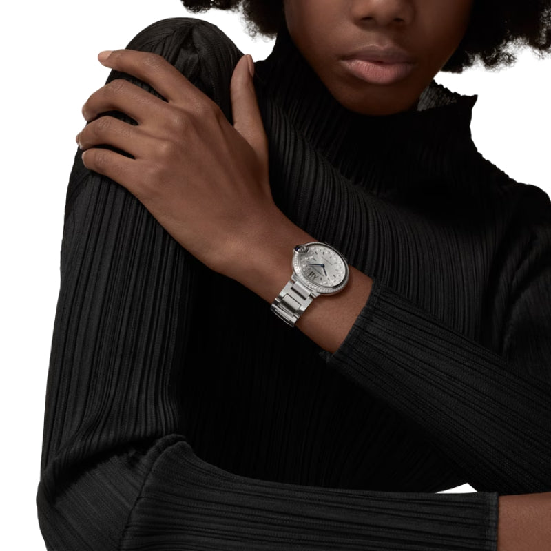 Woman wearing luxury silver watch on her wrist.