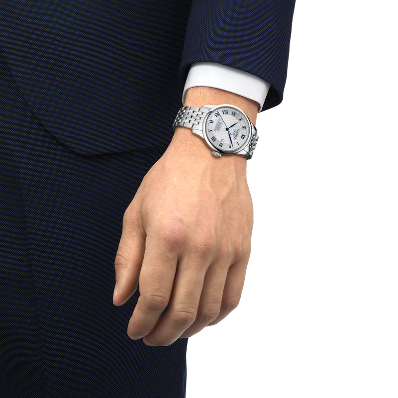 Person wearing Tissot Le LeLocle 20th Anniversary Stainless Steel watch with Silver dial and blue markers