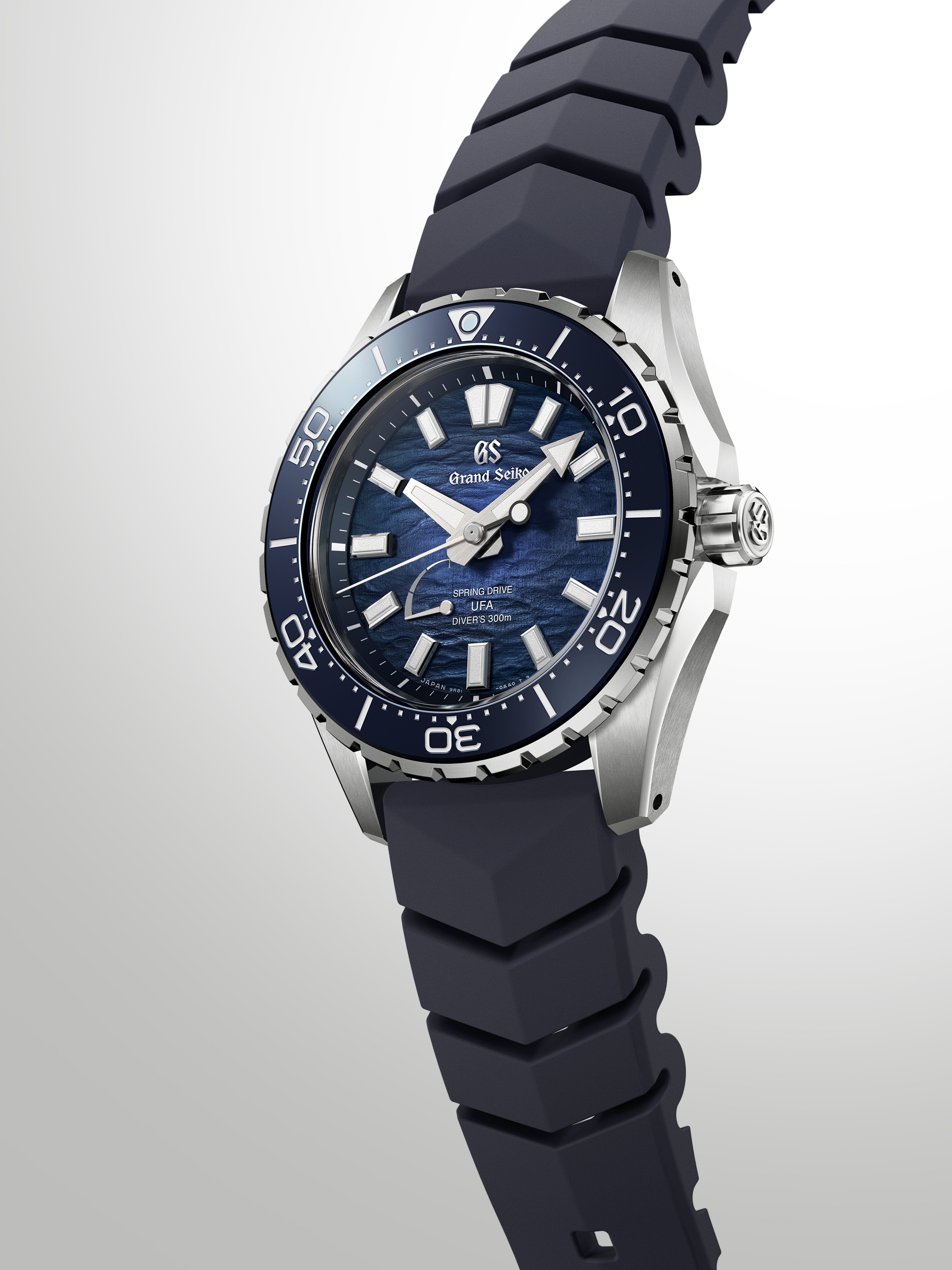 Minimalist aesthetic shot of the watch resting against a clean dark grey backdrop.