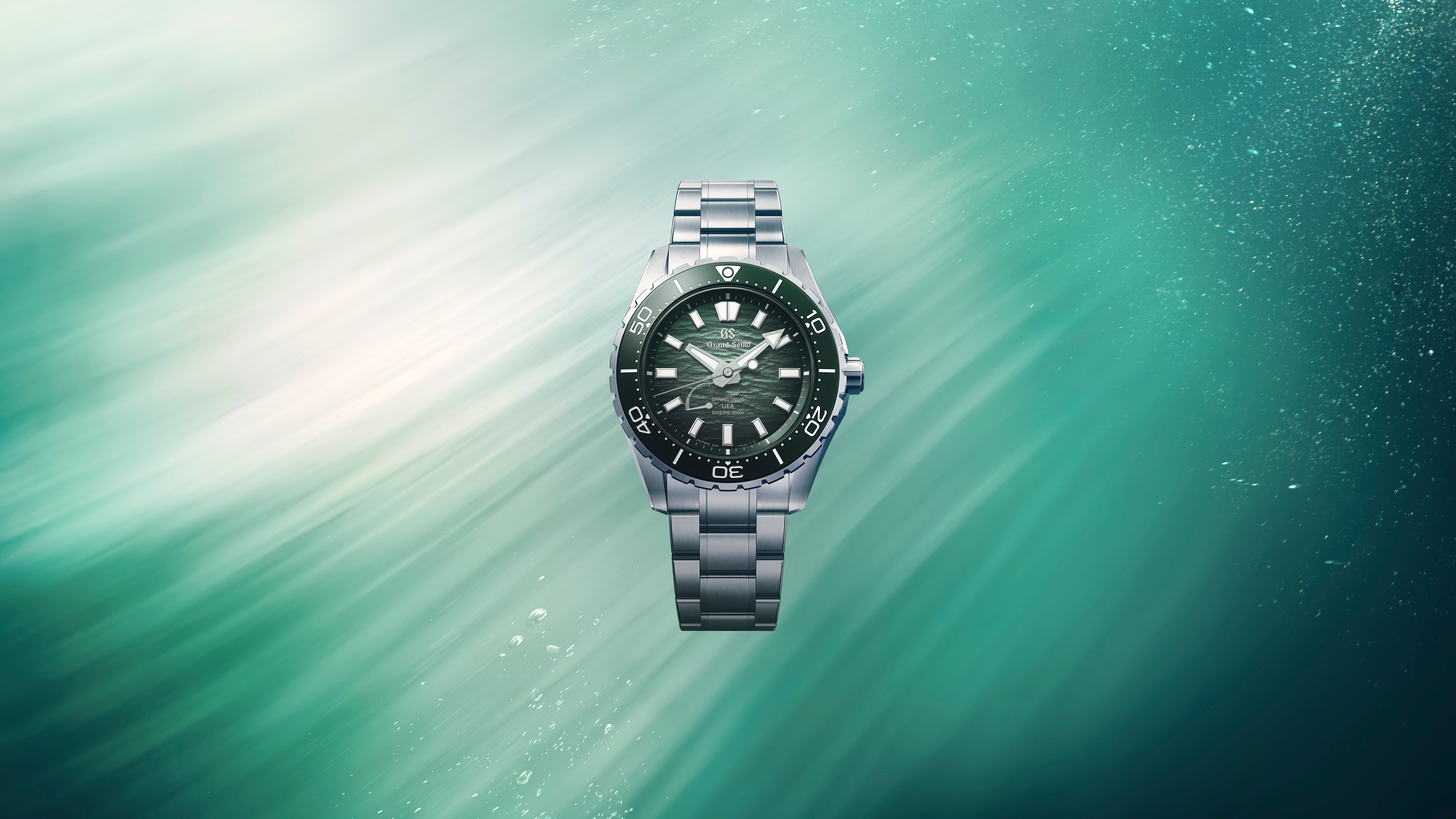 Wide cinematic banner showcasing the watch against a textured grey editorial background.