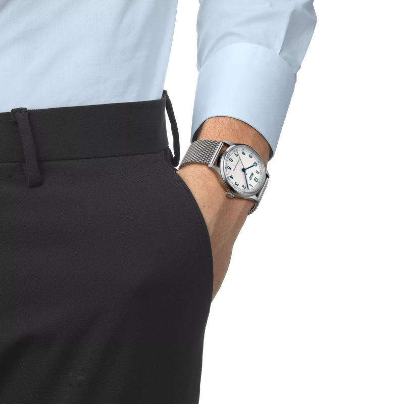 Man wearing TISSOT HERITAGE 1938 AUTOMATIC COSC 39MM Silver dial stainless steel bracelet