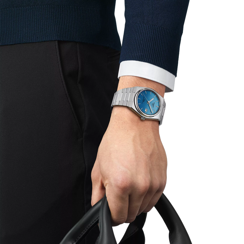 Person wearing Stainless Steel Tissot Watch with blue dial and date indicator