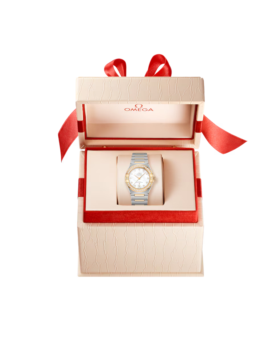 Omega Constellation watch in a cream gift box.