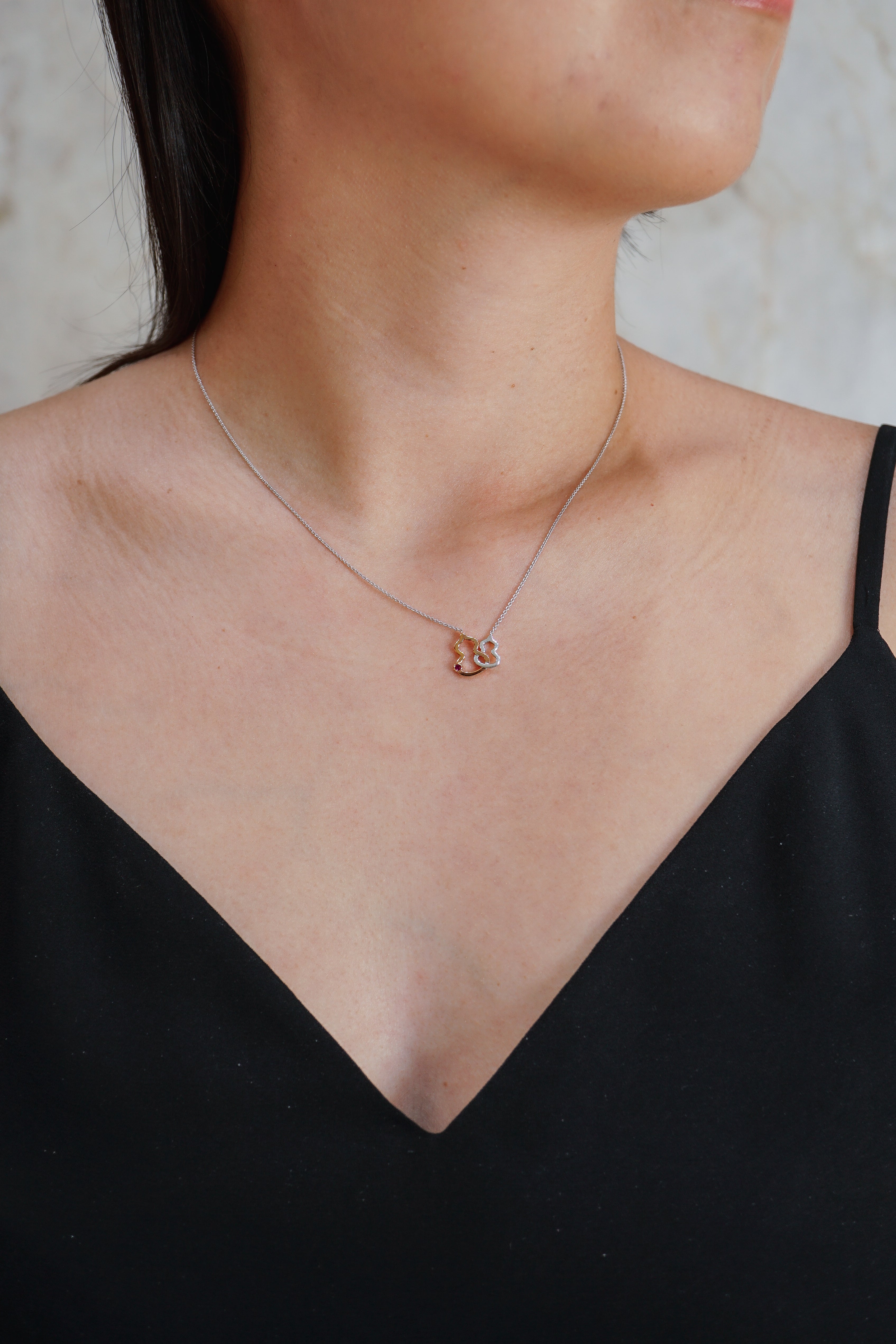 Qeelin Petite Wulu necklace in 18K rose gold and white gold with a ruby